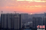 资料图：图为成都城区一角太阳正从东方升起。中新社记者 刘忠俊 摄 - 新浪湖北