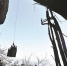 图为：吊车的吊篮从岩顶下降100多米，载着工人到达绝壁上的溶洞洞口 - 新浪湖北
