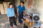 图为荆门市扶贫工作队队员帮村民销售蜂蜜。新华网发 - 新浪湖北
